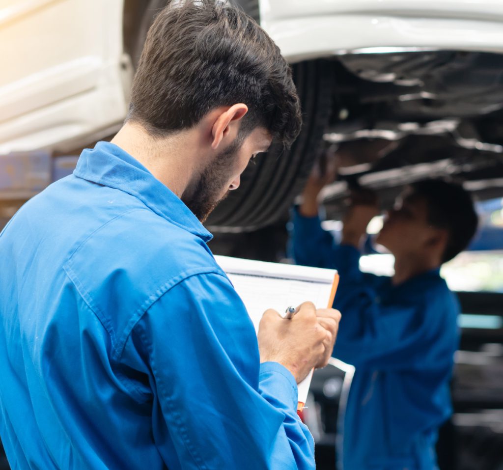 Two mechanics inspecting a vehicle - MOT Testing Walton-on-Thames